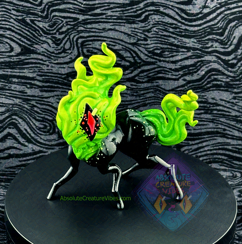 Four legged creature with flaming head and tail, one eye in the center. Black body, eye sclera; neon green flame, pink pupil.
