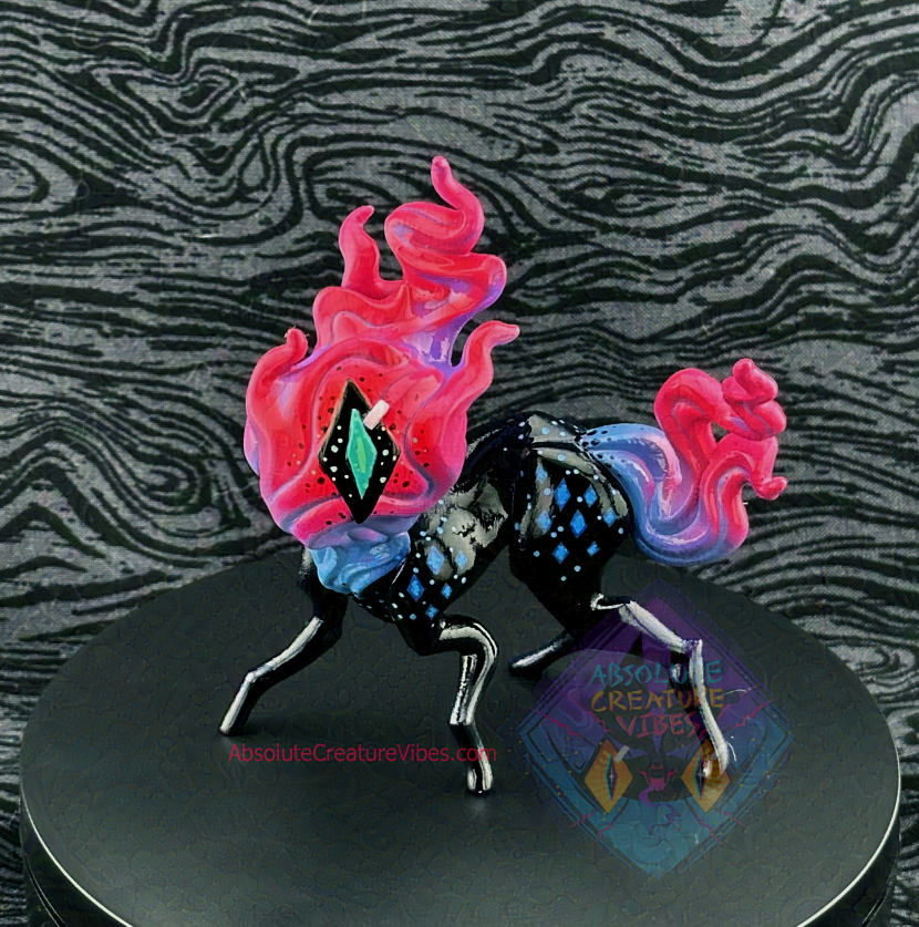 Four legged creature with flaming head and tail, one eye in the center. Blue, purple, and pink flame, black body, sclera, aqua pupil. Blue diamonds on body at shoulders and hips.