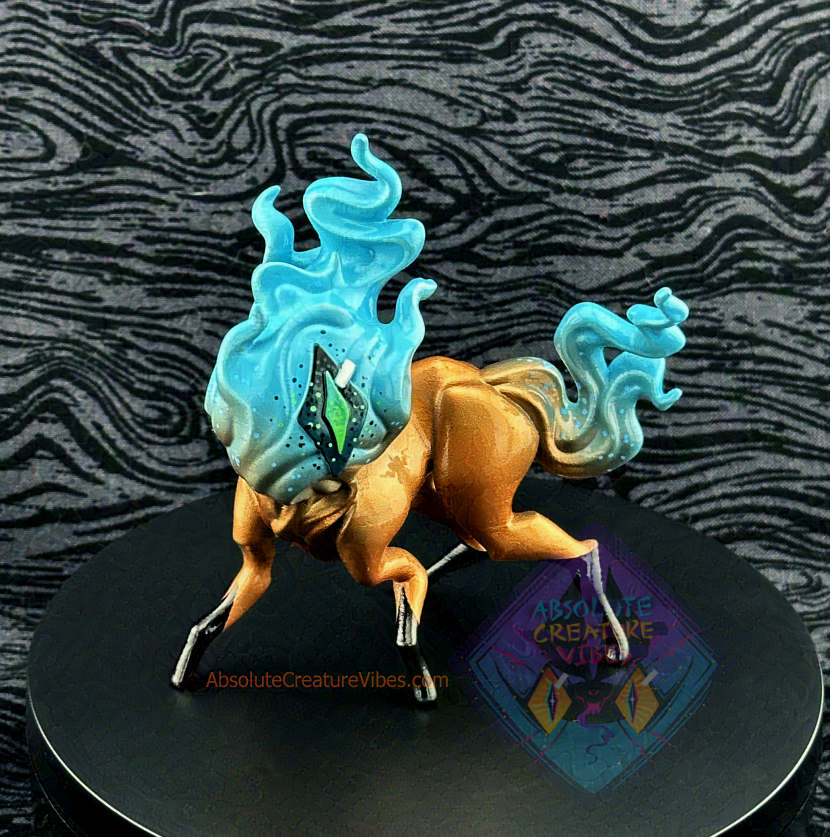 Four legged creature with flaming head and tail, one eye in the center. Blue flame, Gold body, black feet, sclera, green pupil.