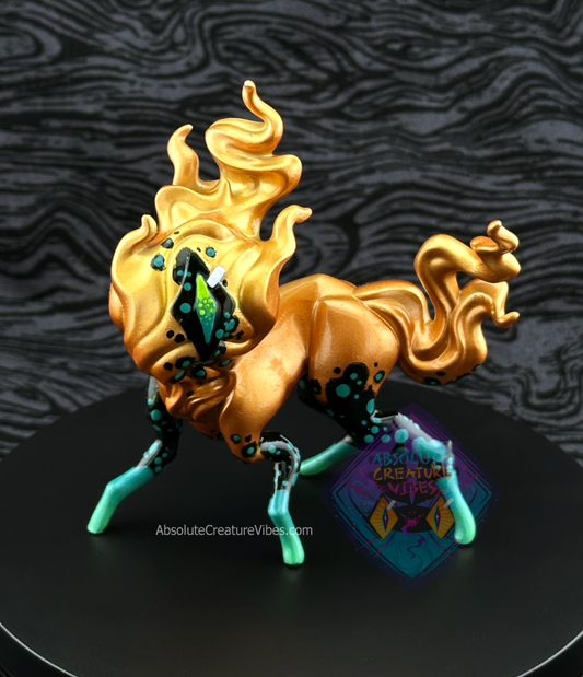 Four legged creature with flaming head and tail, one eye in the center. Copper body with black and green leg accents, black eye.
