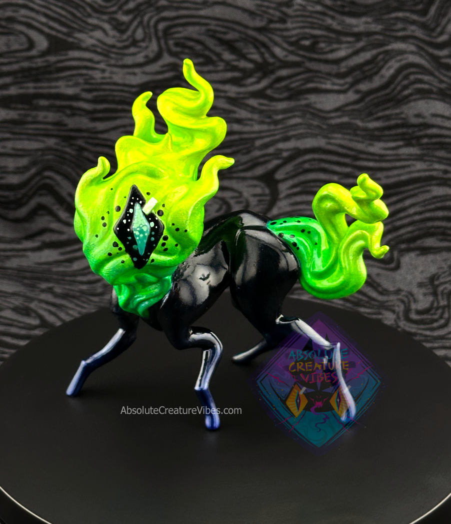Four legged creature with flaming head and tail, one eye in the center. Black body, sclera, dark metallic blue legs, aqua pupil.
