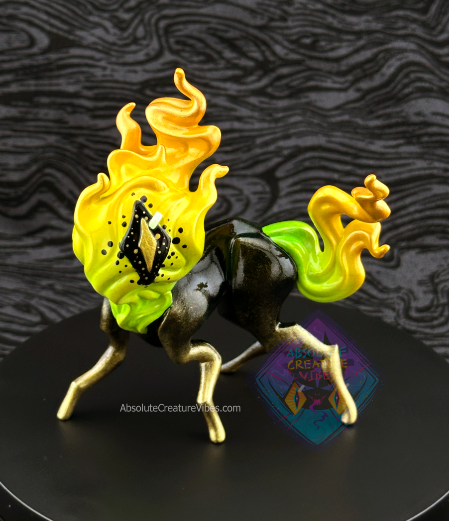 Four legged creature with flaming head and tail, one eye in the center. Green, yellow, and gold flame; black body with gold legs, black sclera, gold pupil.