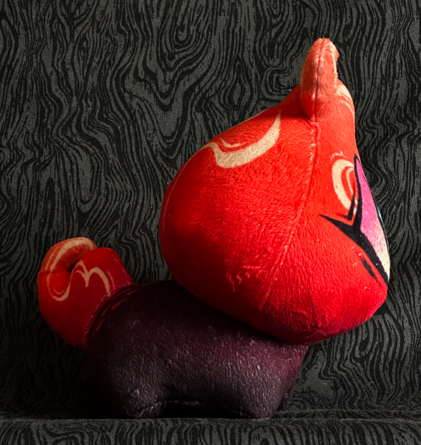Side view, plush toy "Baby Bambi" pink and orange flame, pink and cream eye. mauve-black body.