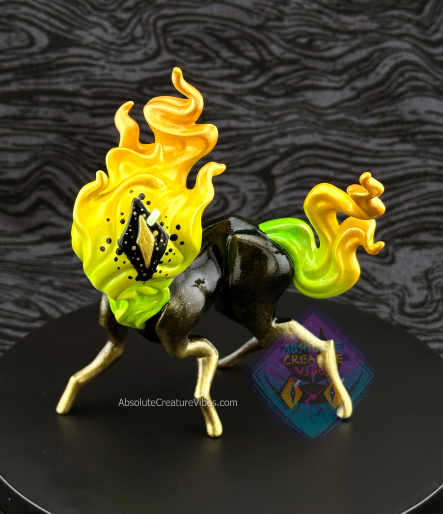 Four legged creature with flaming head and tail, one eye in the center. Green, yellow, and gold flame; black body with gold legs, black sclera, gold pupil. 