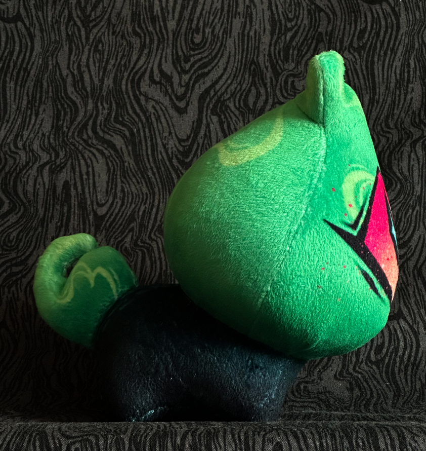 Side view, plush toy "Baby Bambi" acid green flame, pink and orange eye. green-black body.