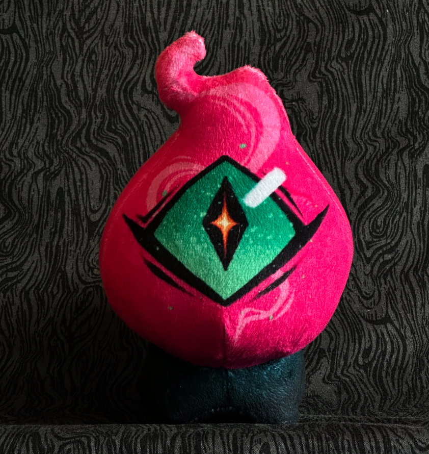 Front view, plush toy "Baby Bambi" hot pink flame, green eye. green-black body.